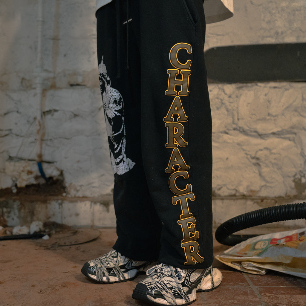 Model wearing Character Development Prayer Sweatpants, black French Terry with semicolon branding